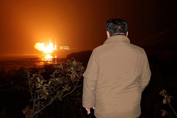 North Korean leader Kin Jong-un watches the launch of North Korea's first reconnaissance satellite Malligyong-1